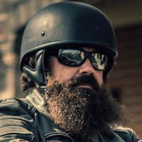 man with a beard wearing a half helmet