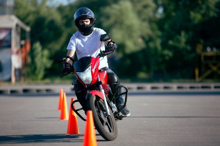 motorcycle rider riding through cones